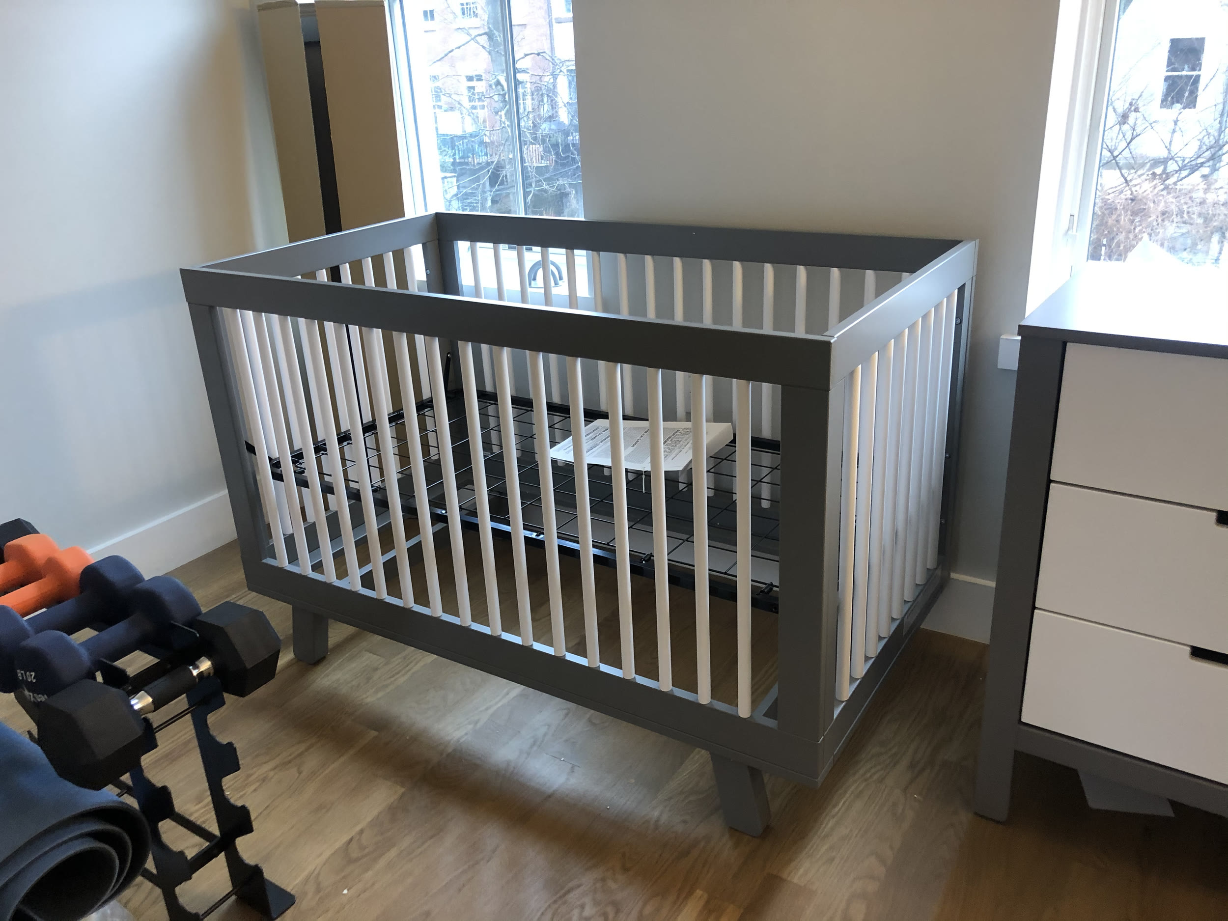 Baby room furniture assembly — crib, changing table, and rocking chair — by Jose Does It.